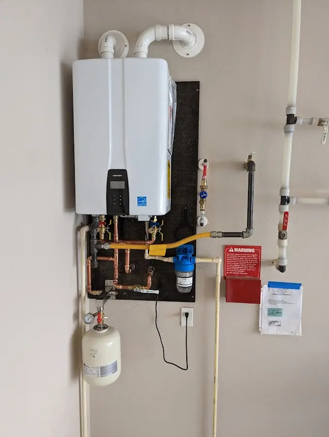 Professional plumber installing copper piping in a Kenhorst home